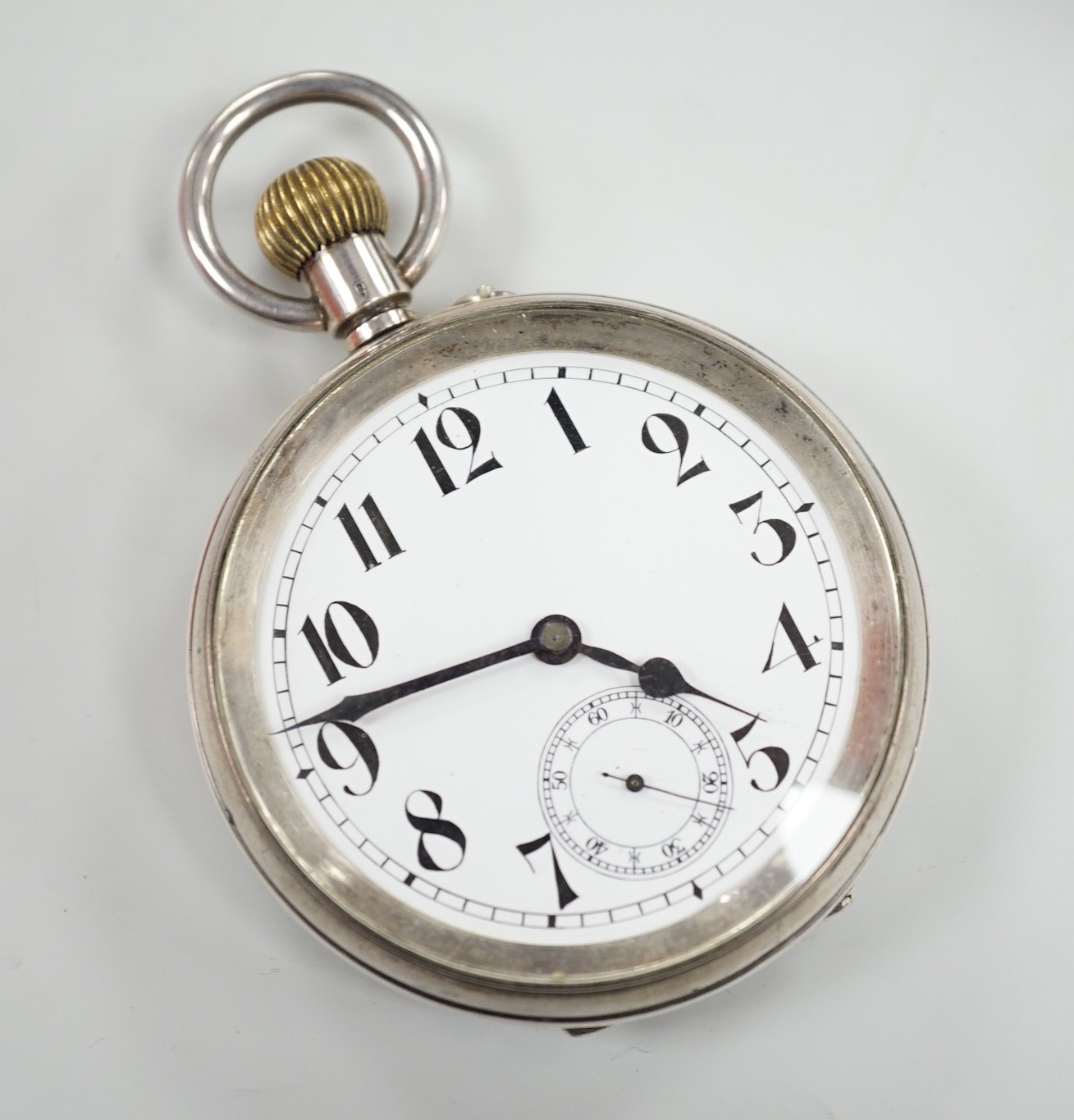 A tortoiseshell mounted travelling watch case, containing a Swiss white metal pocket watch, case diameter 67mm, outer case 11.5cm.